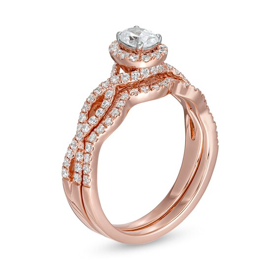 Previously Owned - 1 CT. T.w. Oval Diamond Frame Split Shank Bridal Set in 14K Rose Gold
