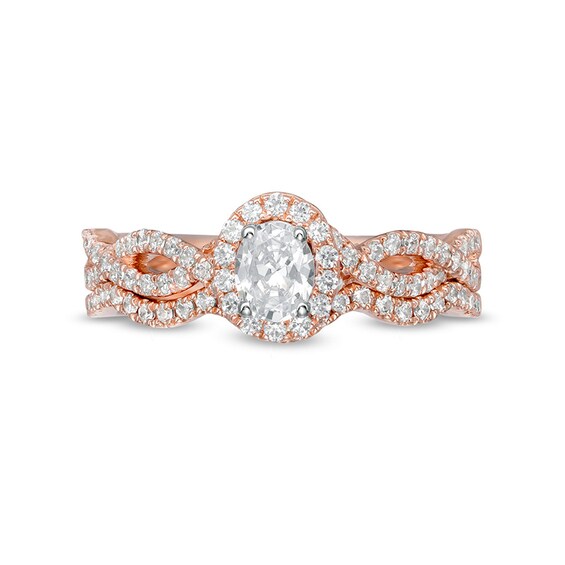 Previously Owned - 1 CT. T.w. Oval Diamond Frame Split Shank Bridal Set in 14K Rose Gold