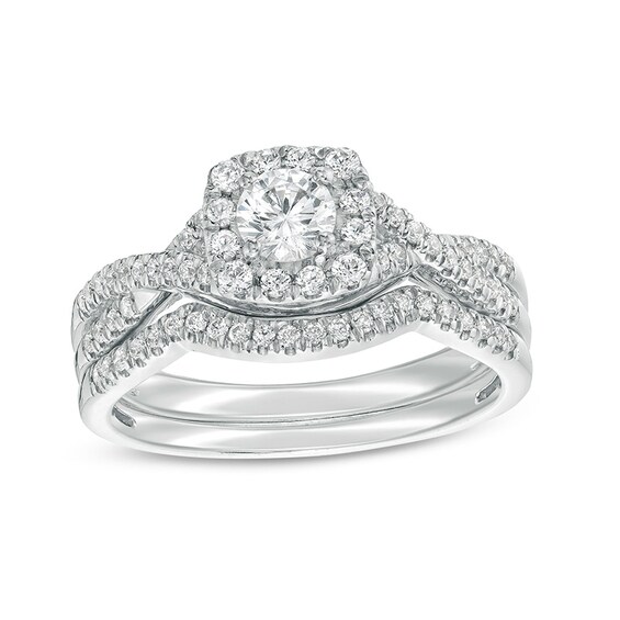 Previously Owned - 3/4 CT. T.w. Diamond Cushion-Shaped Frame Twist Shank Bridal Set in 14K White Gold (I/I2)