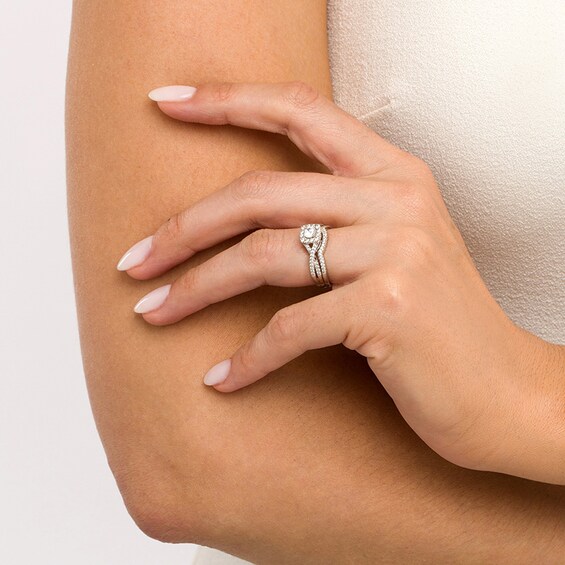 Previously Owned - 3/4 CT. T.w. Diamond Cushion-Shaped Frame Twist Shank Bridal Set in 14K White Gold (I/I2)