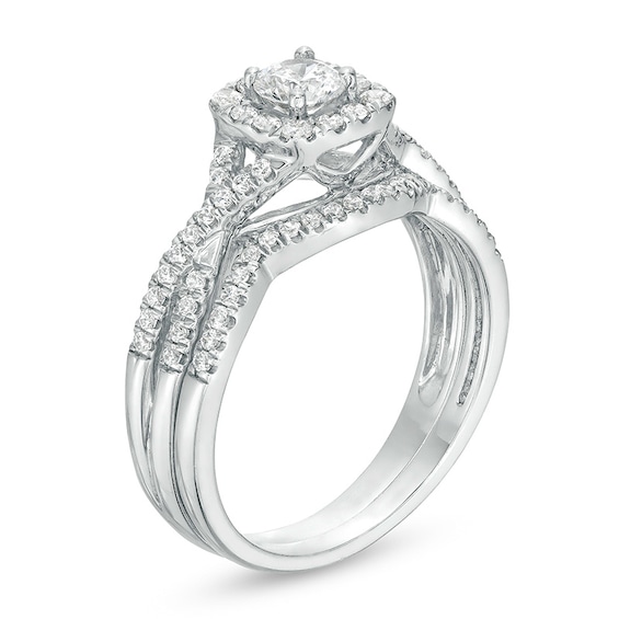 Previously Owned - 3/4 CT. T.w. Diamond Cushion-Shaped Frame Twist Shank Bridal Set in 14K White Gold (I/I2)