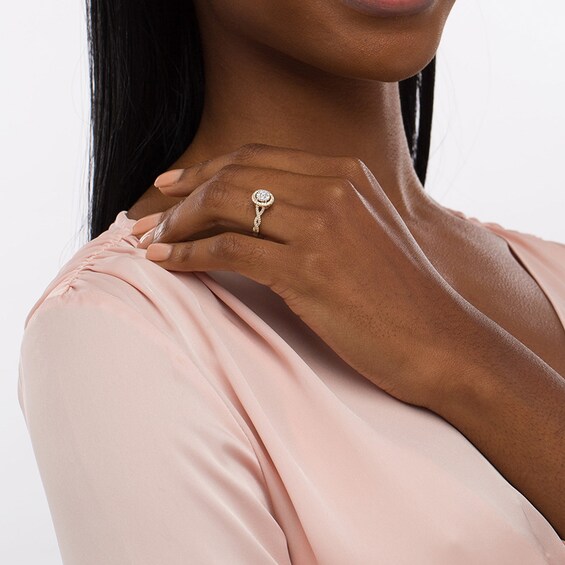 Previously Owned - 1/2 CT. T.w. Oval Multi-Diamond Frame Twist Shank Engagement Ring in 10K Gold