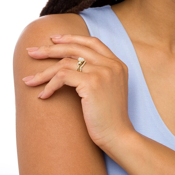 Previously Owned - 1/3 CT. T.w. Quad Diamond Cushion-Shaped Frame Twist Shank Bridal Set in 10K Gold