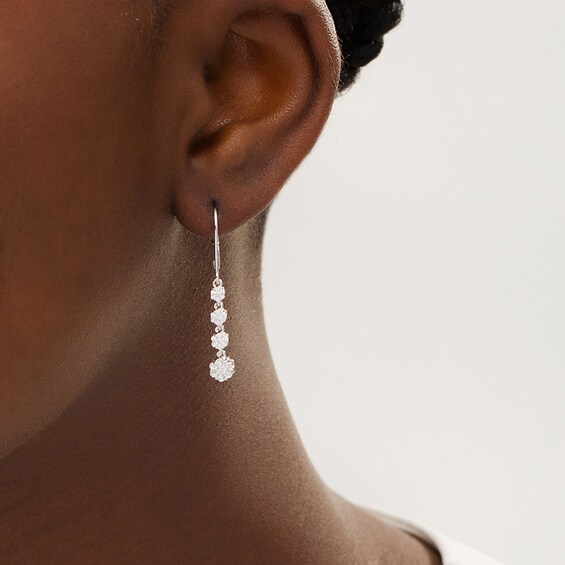 Previously Owned - 1/2 CT. T.w. Multi-Diamond Graduated Flower Dangle Drop Earrings in 10K White Gold