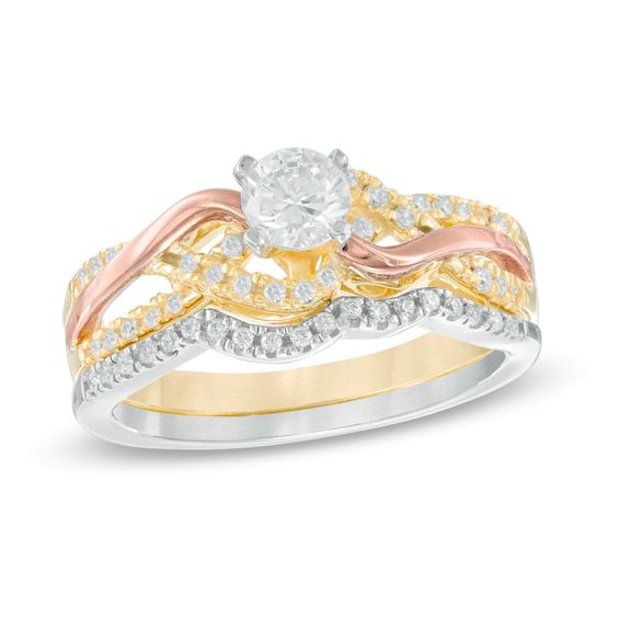 Previously Owned - 1/2 CT. T.w. Diamond Twist Bridal Set in 10K Tri-Tone Gold