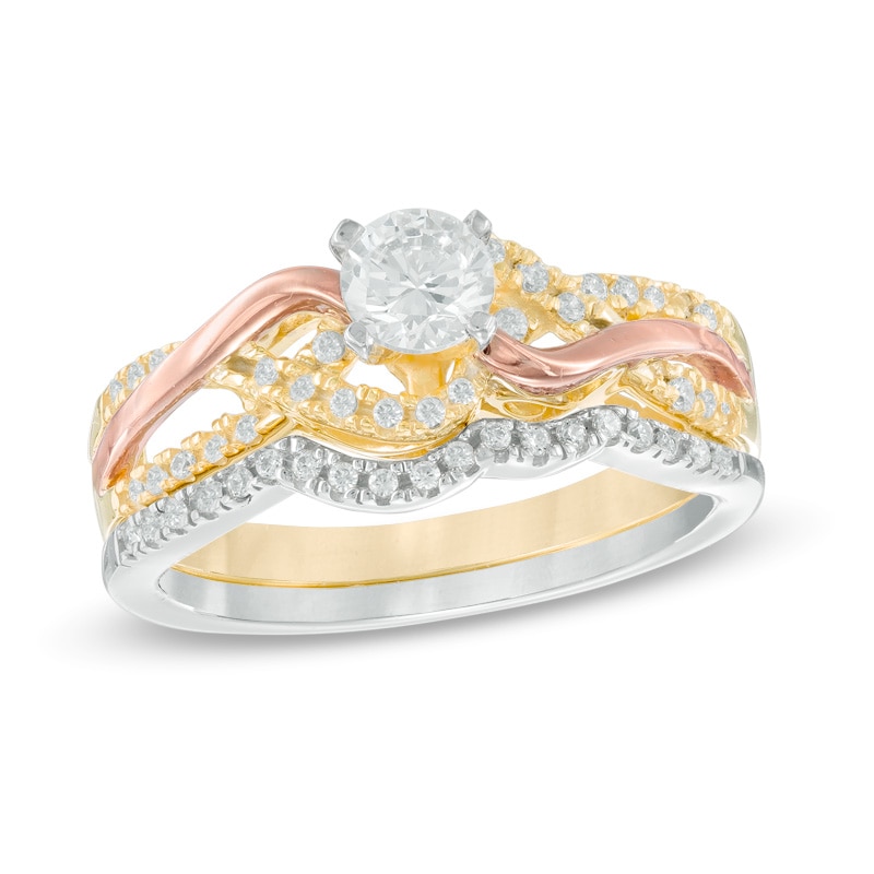 Main Image 1 of Previously Owned - 1/2 CT. T.W. Diamond Twist Bridal Set in 10K Tri-Tone Gold