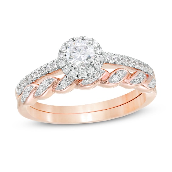 Previously Owned - 1/2 CT. T.w. Diamond Frame Twist Shank Bridal Set in 10K Rose Gold