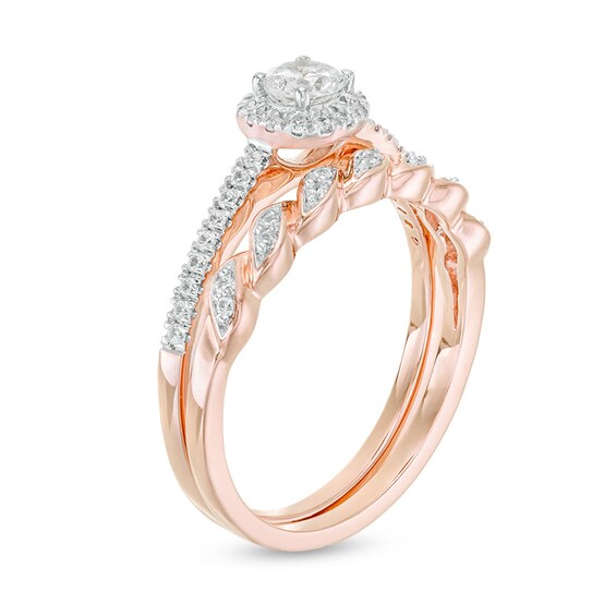 Previously Owned - 1/2 CT. T.w. Diamond Frame Twist Shank Bridal Set in 10K Rose Gold