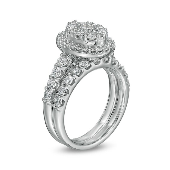 Previously Owned - 2 CT. T.w. Multi-Diamond Oval Diamond Frame Bridal Set in 14K White Gold