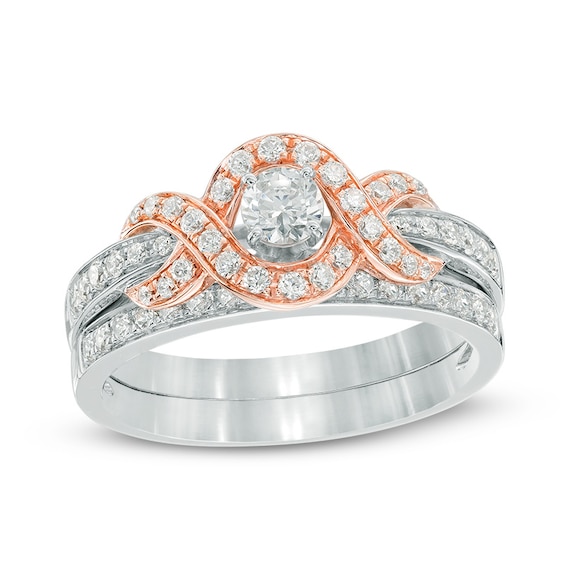 Previously Owned - 3/4 CT. T.w. Diamond Swirl Frame Bridal Set in 14K Two-Tone Gold