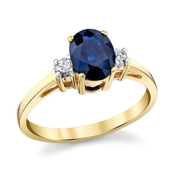 Previously Owned - Oval Blue Sapphire and 1/6 CT. T.w. Diamond Three Stone Ring in 14K Gold