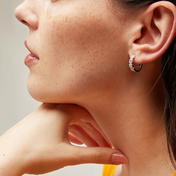 Previously Owned - 1/2 CT. T.w. Cushion-Shaped Multi-Diamond Four Stone Huggie Hoop Earrings in 10K White Gold