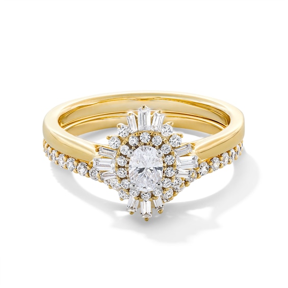 Previously Owned - 3/4 CT. T.w. Oval Diamond Double Sunburst Frame Bridal Set in 14K Gold