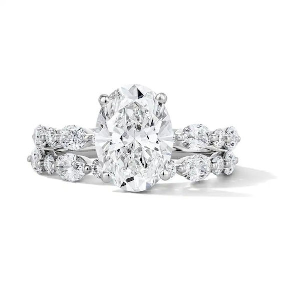 Previously Owned - 4 CT. T.w. Oval and Round Lab-Grown Diamond Alternating Shank Bridal Set in 14K White Gold (F/Vs2)
