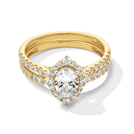 Previously Owned - 1-1/2 CT. T.w. Oval Diamond Frame Bridal Set in 14K Gold