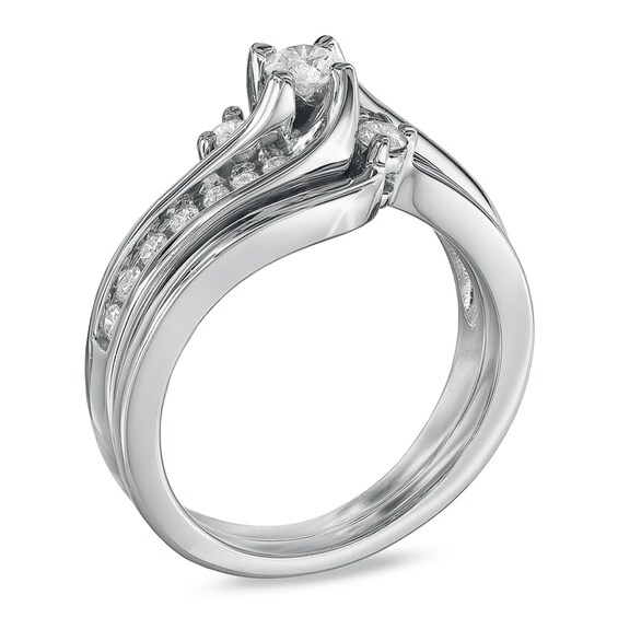 Previously Owned - 1/2 CT. T.w. Diamond Three Stone Swirl Soldered Bridal Set in 14K White Gold