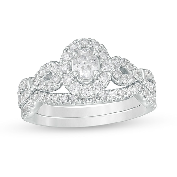 Previously Owned - 1 CT. T.w. Oval Diamond Frame Collar Soldered Bridal Set in 14K White Gold (I/I2)