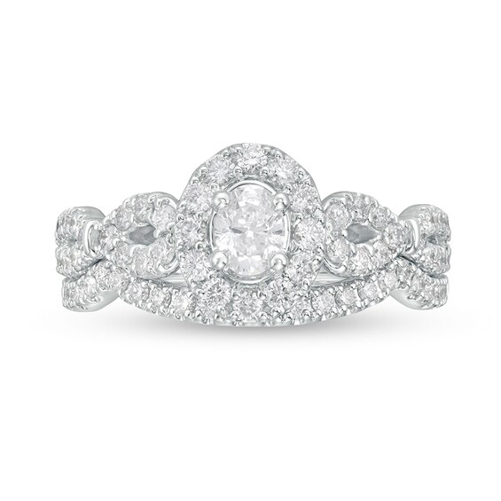 Previously Owned - 1 CT. T.w. Oval Diamond Frame Collar Soldered Bridal Set in 14K White Gold (I/I2)