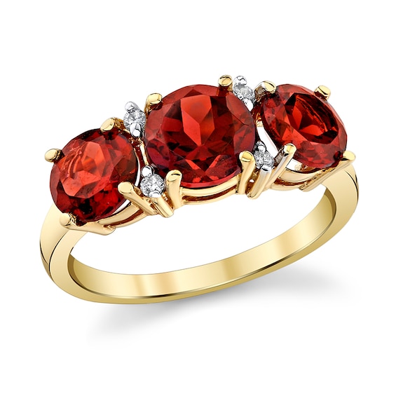 Previously Owned - Garnet and 1/20 CT. T.w. Diamond Three Stone Ring in 14K Gold