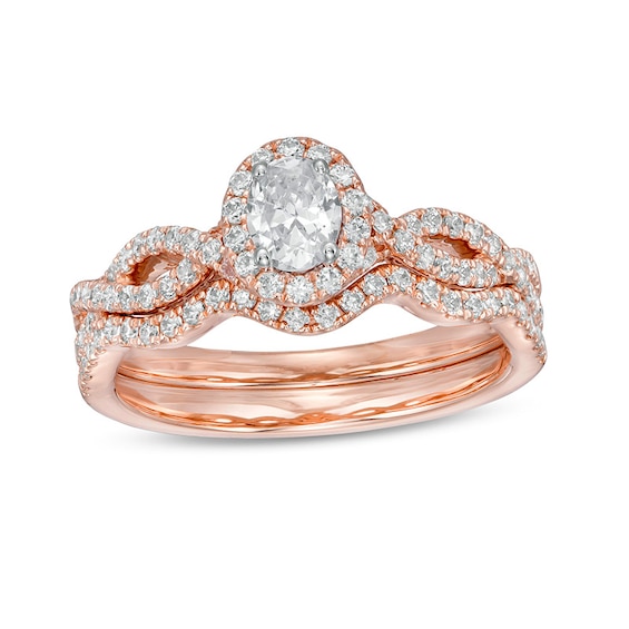 Previously Owned - 1 CT. T.w. Oval Diamond Frame Split Shank Soldered Bridal Set in 14K Rose Gold (I/I2)