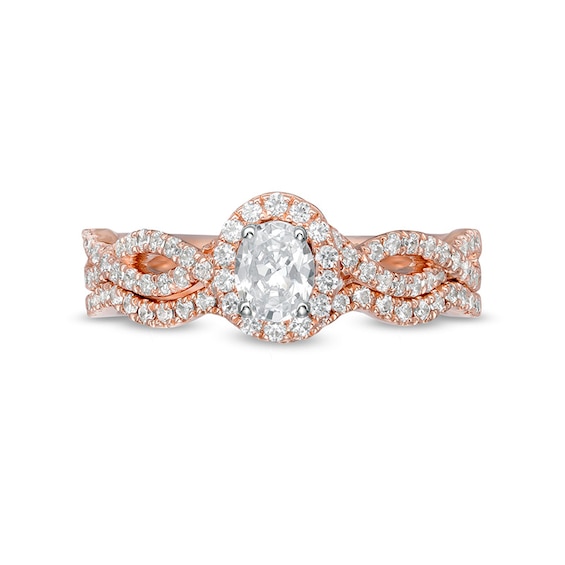 Previously Owned - 1 CT. T.w. Oval Diamond Frame Split Shank Soldered Bridal Set in 14K Rose Gold (I/I2)
