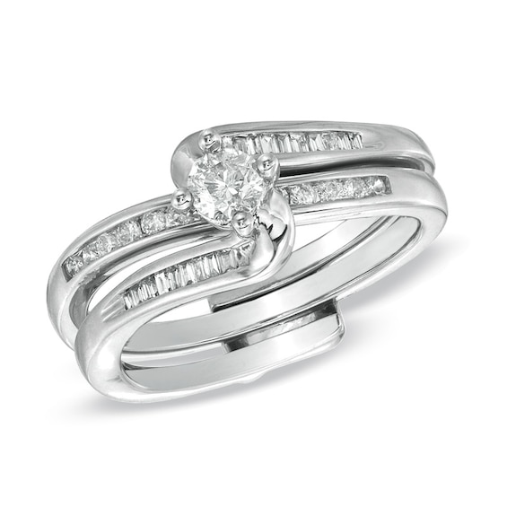 Previously Owned - 1/2 CT. T.w. Round and Baguette Diamond Wave Soldered Bridal Set in 10K White Gold