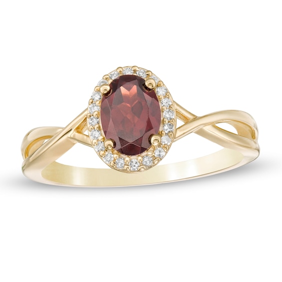 Previously Owned - Oval Garnet and 1/15 CT. T.w. Diamond Frame Twist Shank Ring in 10K Gold