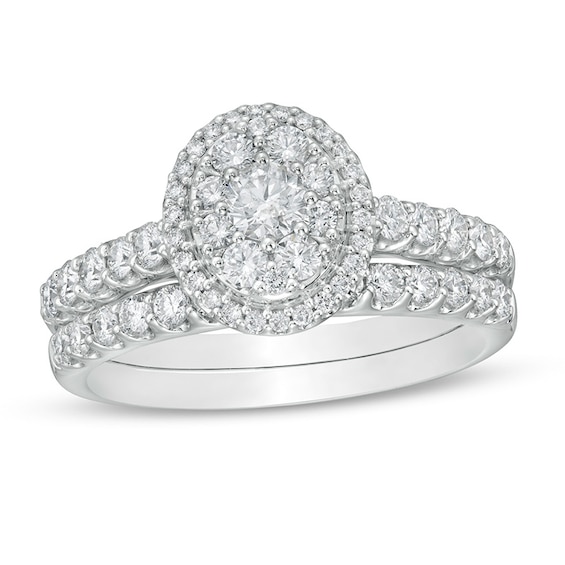 Previously Owned - 1 CT. T.w. Oval Multi-Diamond Frame Soldered Bridal Set in 14K White Gold