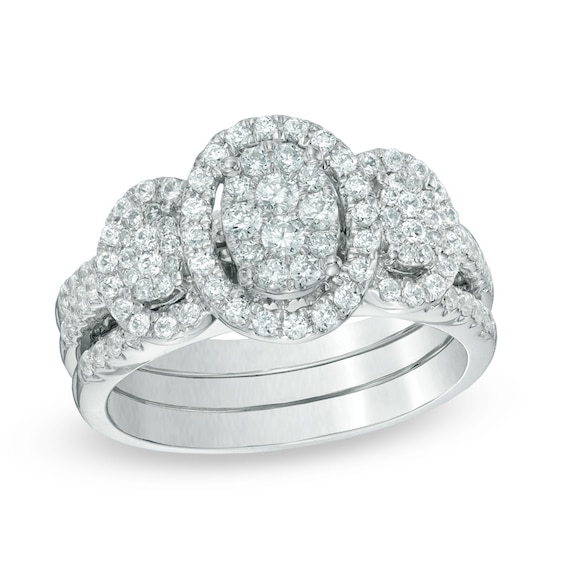 Previously Owned - 1 CT. T.w. Diamond Oval Frame Three Stone Cluster Three Piece Soldered Bridal Set in 10K White Gold