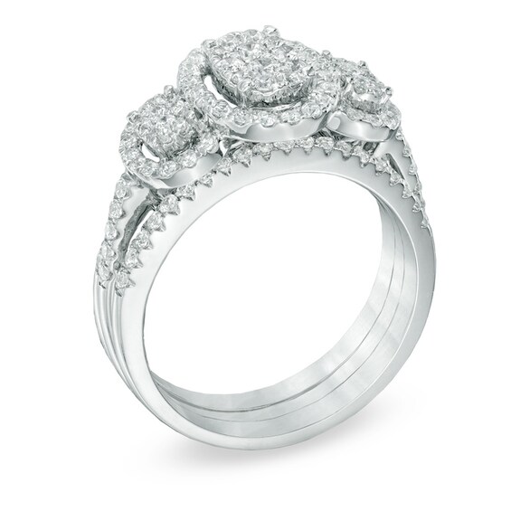 Previously Owned - 1 CT. T.w. Diamond Oval Frame Three Stone Cluster Three Piece Soldered Bridal Set in 10K White Gold