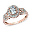 Thumbnail Image 0 of Oval Aquamarine and 1/6 CT. T.W. Diamond Frame Vine Ring in 10K Rose Gold